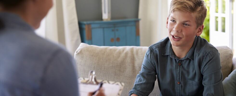 Teenage Boy With Problem Talking With Counselor At Home