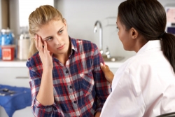 young blonde girl having a discussion with her counselor